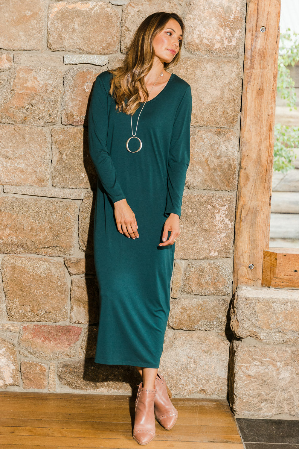 Model Amanda wearing size 10 of The Long Sleeve Bamboo Dress in colour Forest (Green), from the front, showing the whole outfit