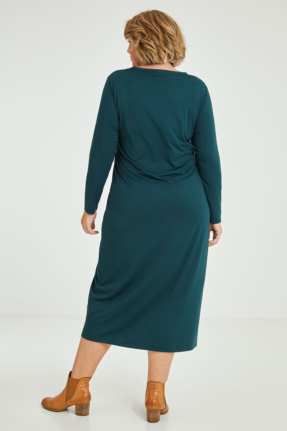 Model Fiona wearing size 16 of The Long Sleeve Bamboo Dress in colour Forest (Green), from the back