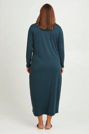 Model Monique wearing size 14 of The Long Sleeve Bamboo Dress in colour Forest (Green), from the back