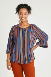 Model Noli wearing size 14 of The Long Sleeve Crew Neck Shirt in colour Camelstrip (Blue), from the front, cropped image
