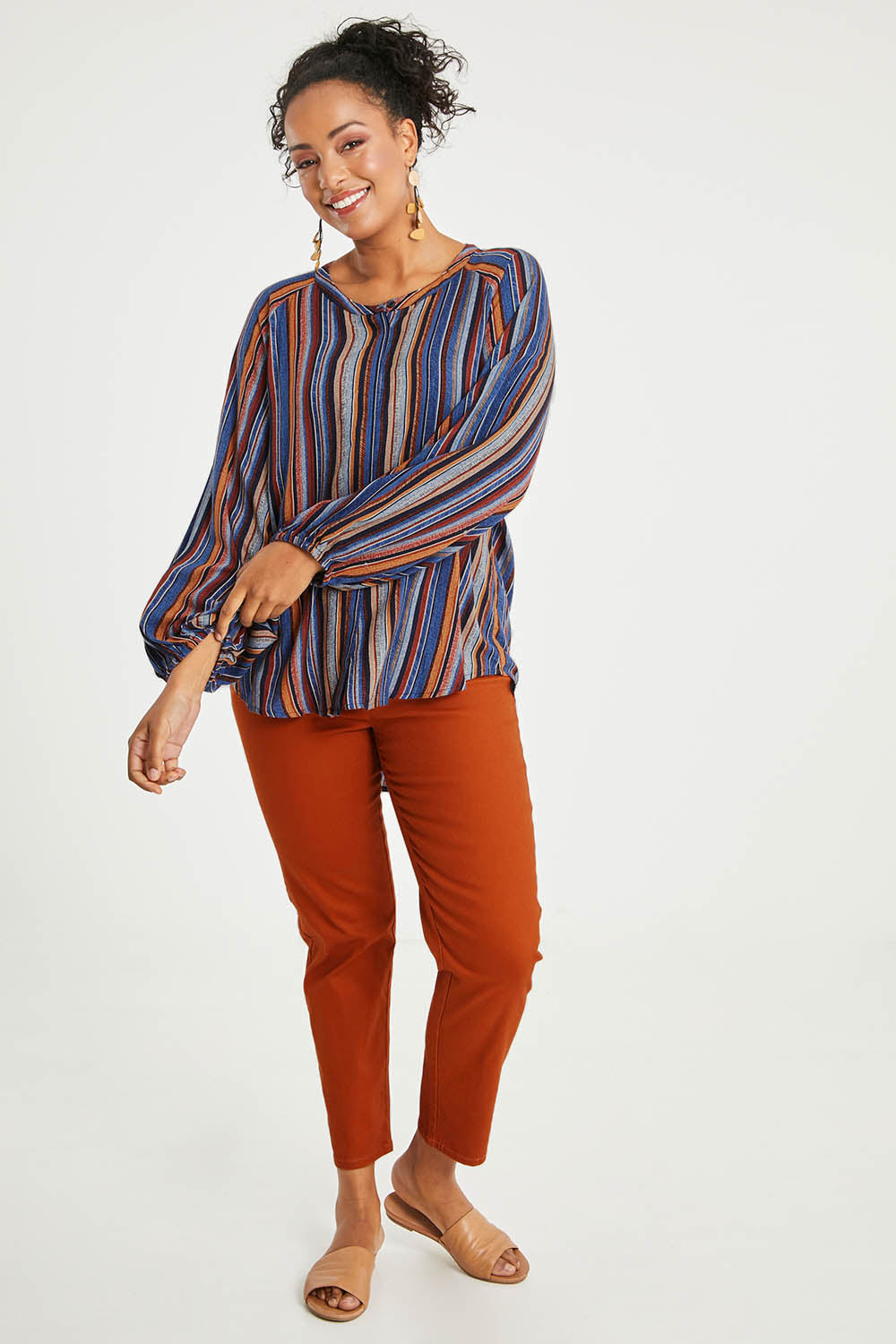 Model Noli wearing size 14 of The Long Sleeve Crew Neck Shirt in colour Camelstrip (Blue), from the front, showing the whole outfit