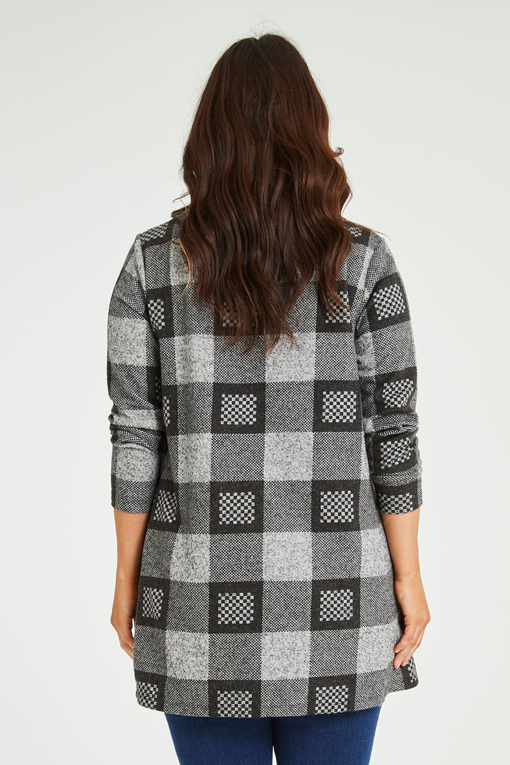 Model Laura wearing size 14 of The Woolly Knit High Low Tunic in colour Blackgrey (Black), from the back