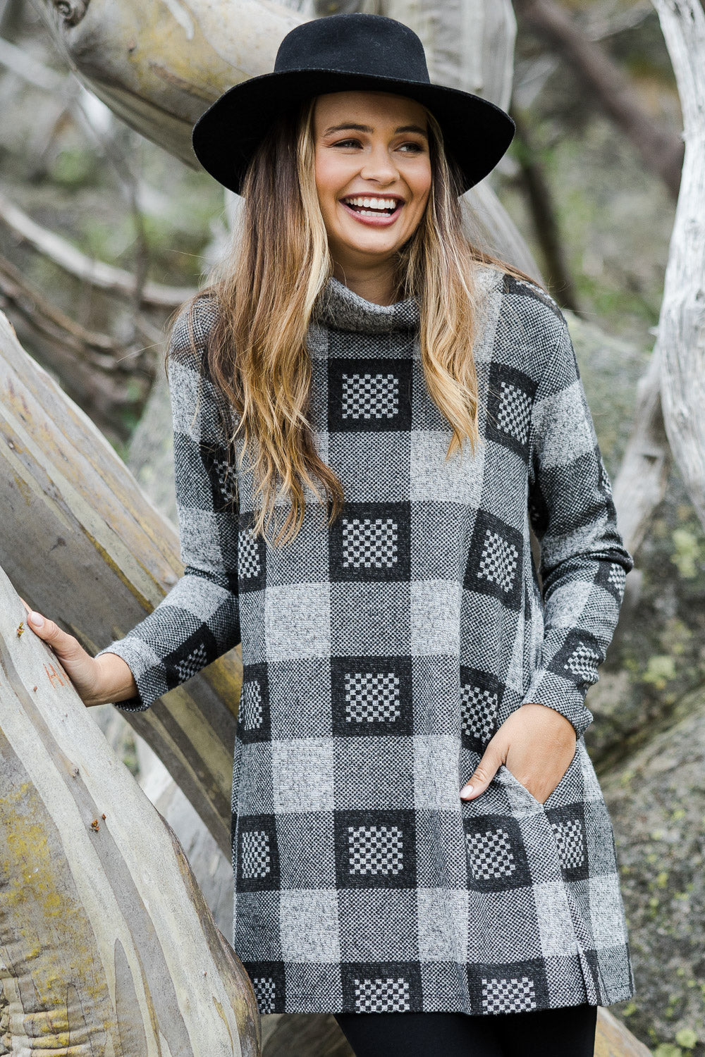 Model Tahlia wearing size 10 of The Woolly Knit High Low Tunic in colour Blackgrey (Black), from the front, showing the whole outfit