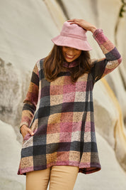 Model Amanda wearing size 10 of The Woolly Knit High Low Tunic in colour Pinkcheck (Pink), from the front, showing the whole outfit