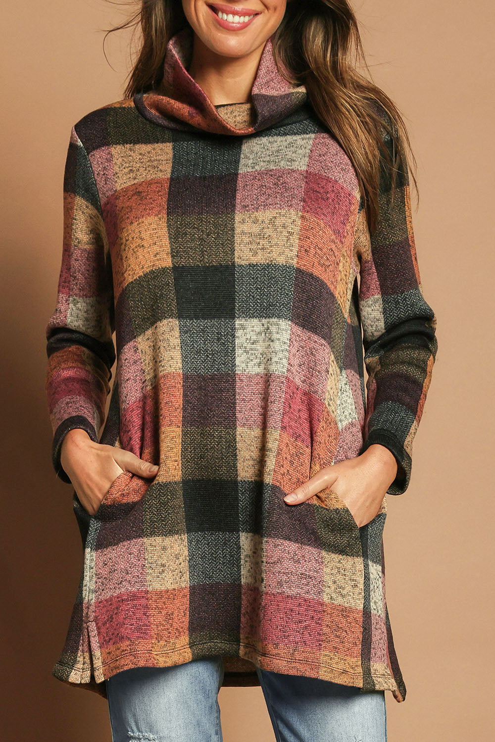 Model Madeline wearing size 10 of The Woolly Knit High Low Tunic in colour Pinkcheck (Pink), from the front, cropped image