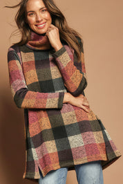 Model Madeline wearing size 10 of The Woolly Knit High Low Tunic in colour Pinkcheck (Pink), from the front, showing the whole outfit