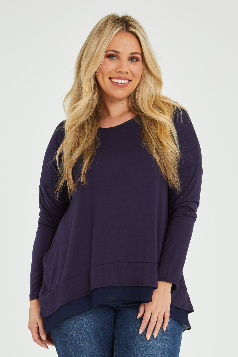 Model Katie wearing size 16 of The Chiffon Underlay Layered Tee in colour Darknavy (Blue), from the front, cropped image