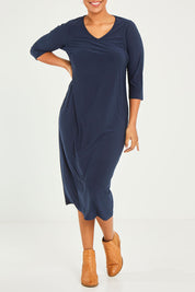 Model Noli wearing size 14 of The Recycled Everyday V Neck Dress in colour Navy (Blue), from the front, cropped image