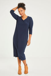 Model Noli wearing size 14 of The Recycled Everyday V Neck Dress in colour Navy (Blue), from the front, showing the whole outfit