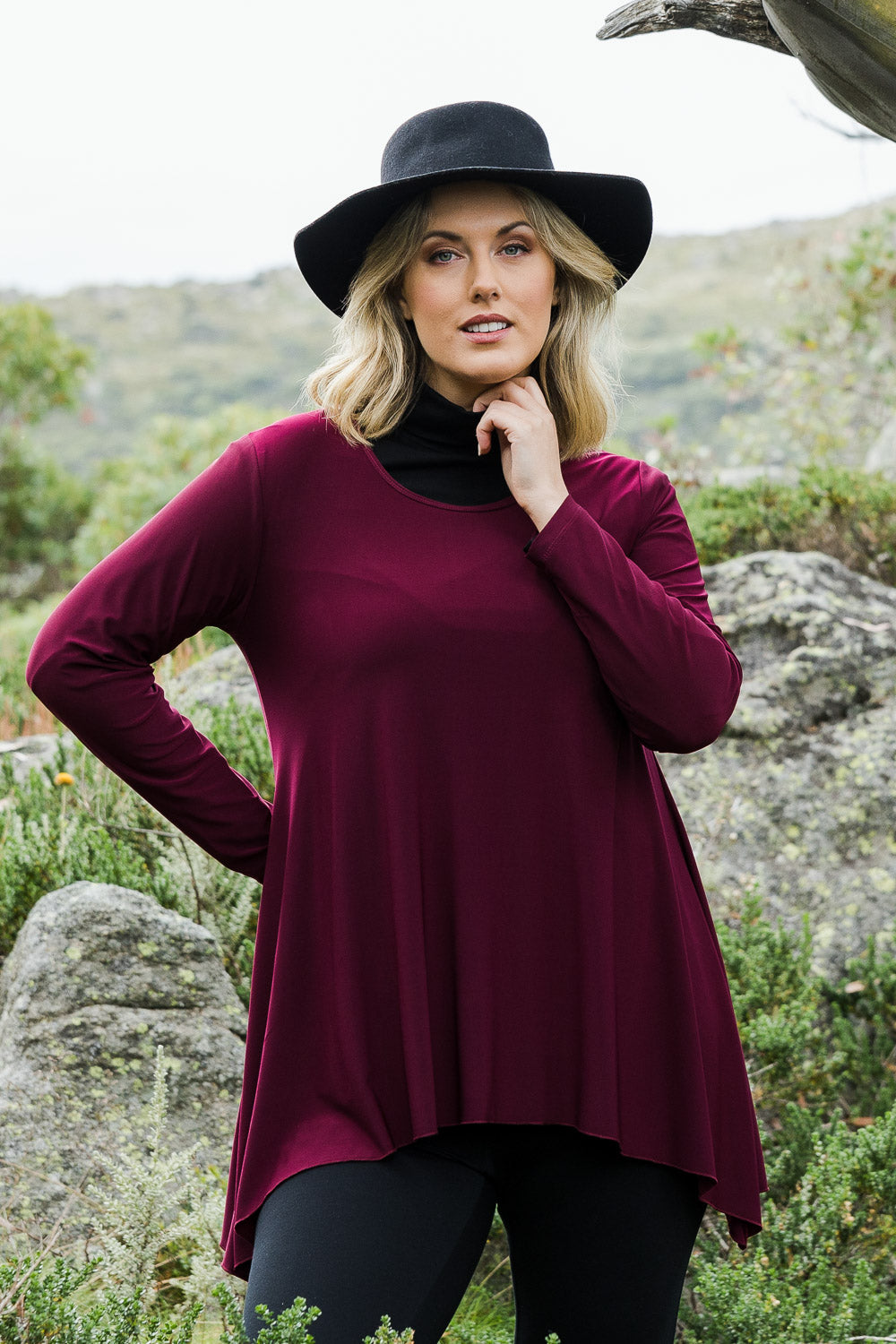 Model Jess wearing size 14 of The Recycled Swing Top in colour Burgundy (Red), from the front, showing the whole outfit