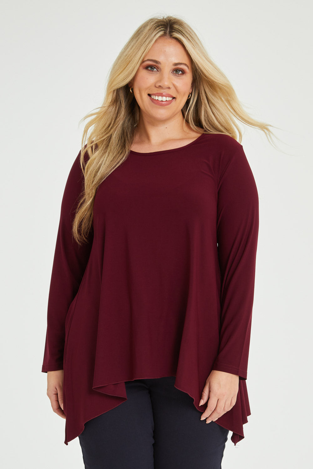 Model Katie wearing size 16 of The Recycled Swing Top in colour Burgundy (Red), from the front, cropped image