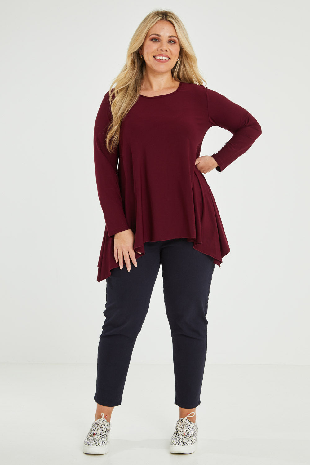Model Katie wearing size 16 of The Recycled Swing Top in colour Burgundy (Red), from the front, showing the whole outfit