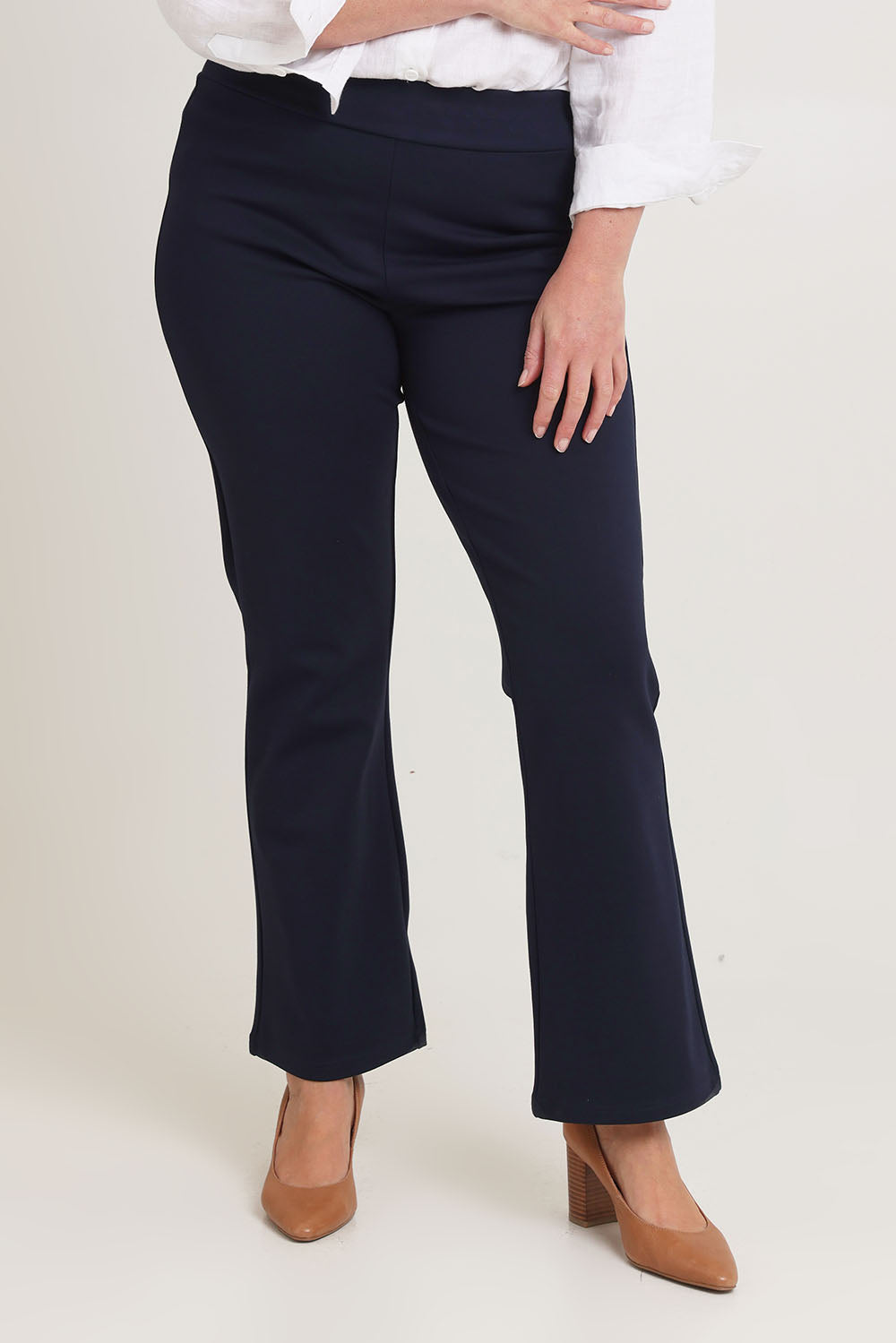 Model Chanel wearing size 16 of The Pull On Ponte Boot Leg Pant in colour Darknavy (Blue), from the front, cropped image