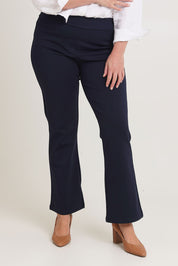 Model Chanel wearing size 16 of The Pull On Ponte Boot Leg Pant in colour Darknavy (Blue), from the front, cropped image