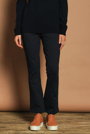 Model Madeline wearing size 10 of The Pull On Ponte Boot Leg Pant in colour Darknavy (Blue), from the front, cropped image