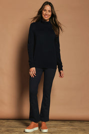 Model Madeline wearing size 10 of The Pull On Ponte Boot Leg Pant in colour Darknavy (Blue), from the front, showing the whole outfit