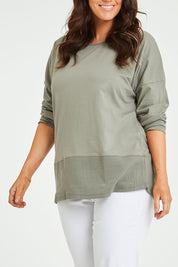 Model Laura wearing size 14 of The Rib Trim Long Sleeve Tee in colour Olive (Green), from the front, cropped image