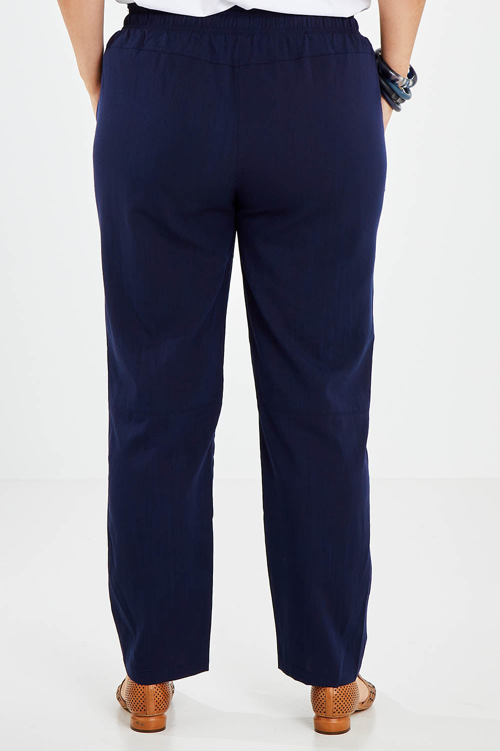 Model Jess wearing size 14 of The Easy Wear Pant in colour Navy (Blue), from the back