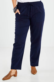 Model Jess wearing size 14 of The Easy Wear Pant in colour Navy (Blue), from the front, cropped image