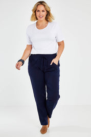 Model Jess wearing size 14 of The Easy Wear Pant in colour Navy (Blue), from the front, showing the whole outfit
