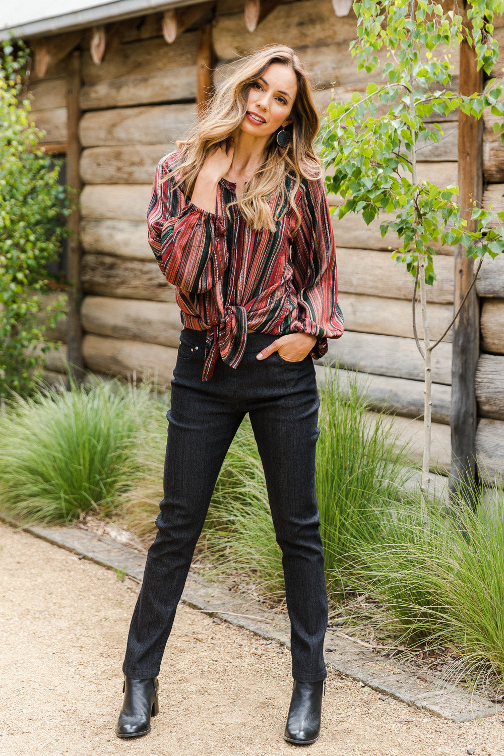 Model Amanda wearing size 10 of The 7/8 Pull On Jean in colour Blackdenim (Black), from the front, showing the whole outfit