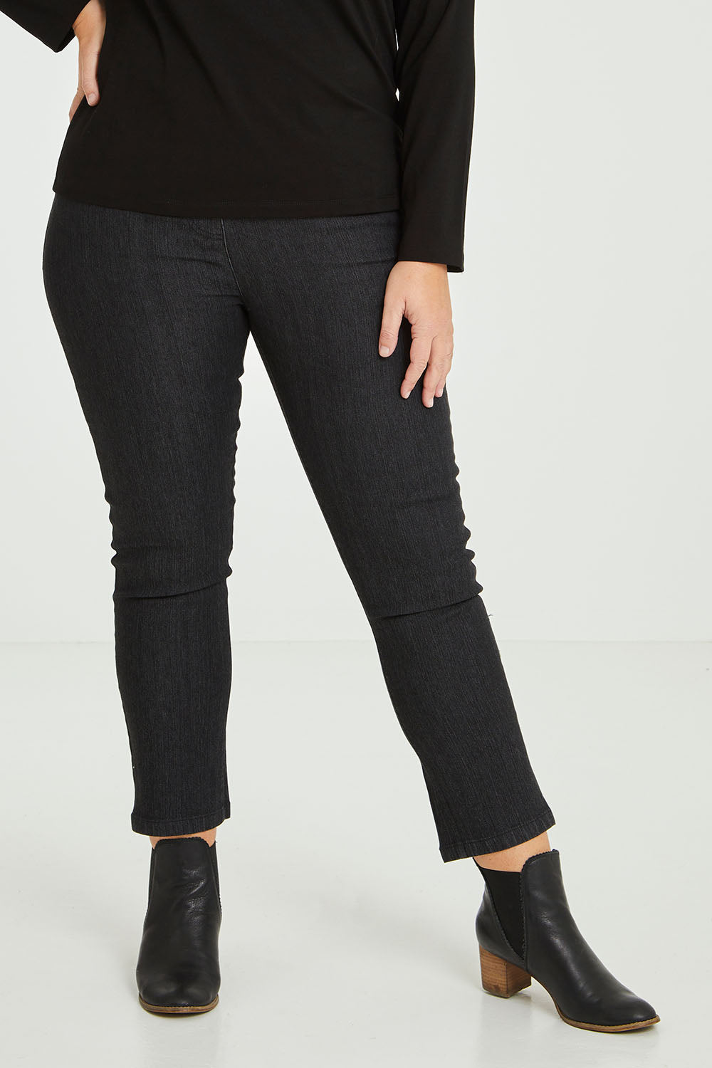 Model Fiona wearing size 16 of The 7/8 Pull On Jean in colour Blackdenim (Black), from the front, cropped image