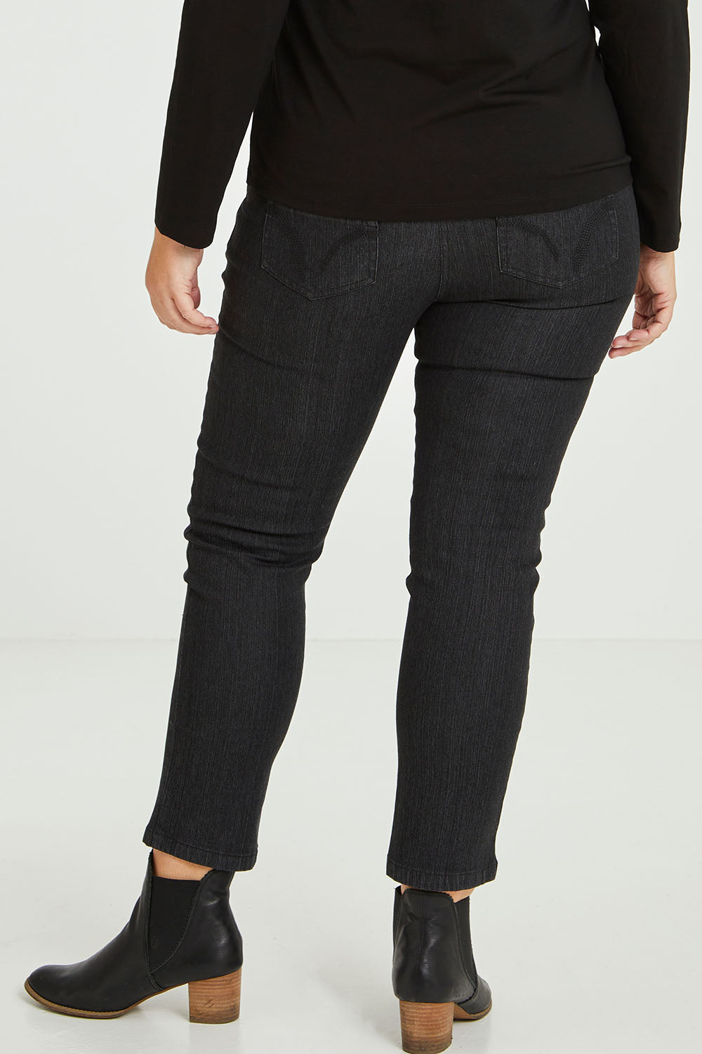 Model Fiona wearing size 16 of The 7/8 Pull On Jean in colour Blackdenim (Black), from the front, cropped image