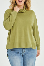 Model Jess wearing size L of The Essential Soft High Low Jumper in colour Avocado (Green), from the front, cropped image