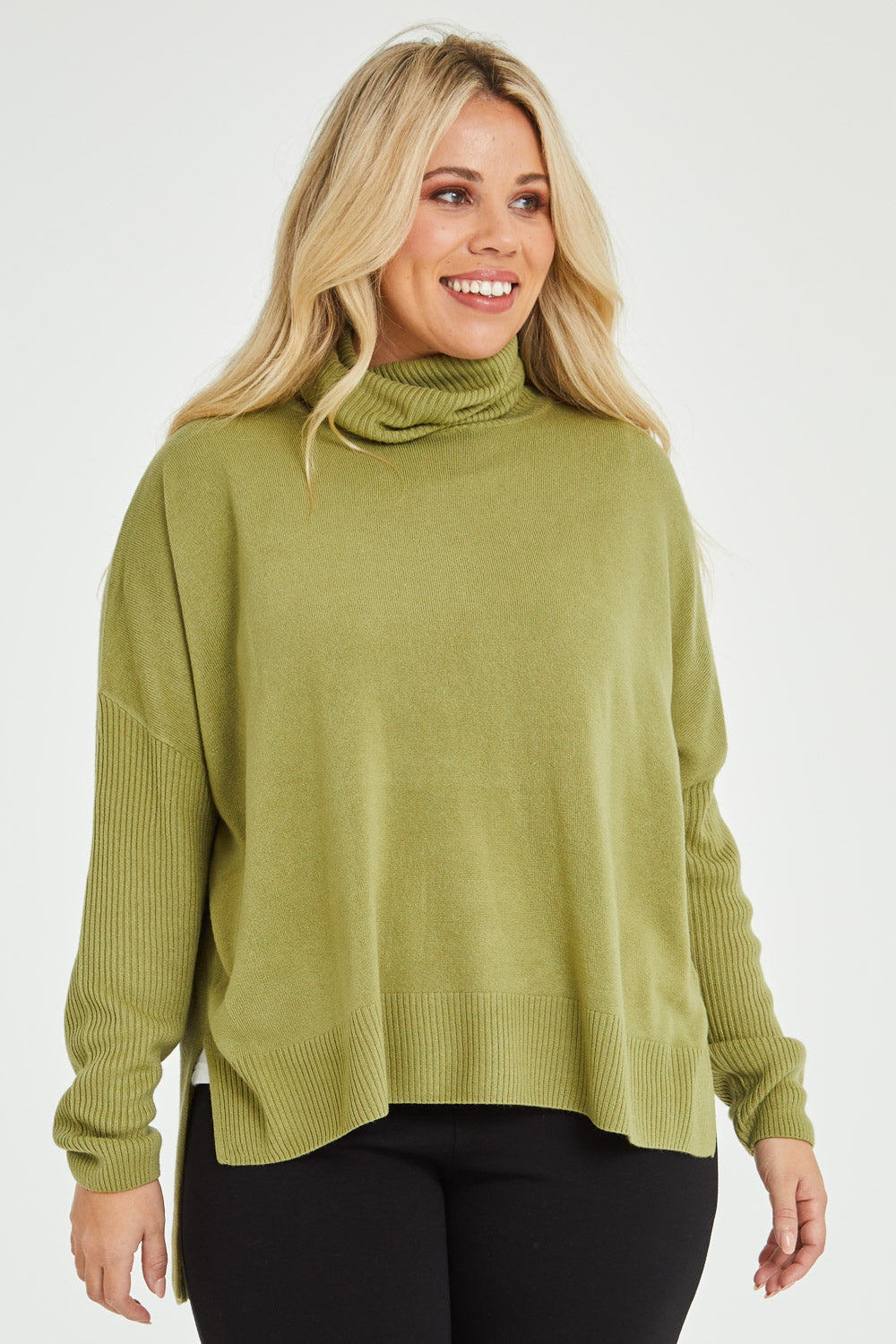 Model Katie wearing size XL of The Essential Soft High Low Jumper in colour Avocado (Green), from the front, cropped image