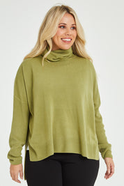 Model Katie wearing size XL of The Essential Soft High Low Jumper in colour Avocado (Green), from the front, cropped image