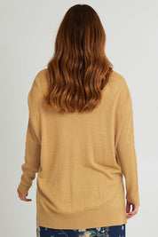 Model Laura wearing size L of The Essential Soft High Low Jumper in colour Biscuit, from the back