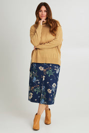 Model Laura wearing size L of The Essential Soft High Low Jumper in colour Biscuit, from the front, showing the whole outfit