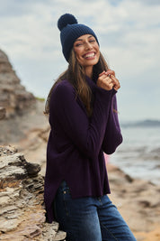 Model Amanda wearing size S of The Essential Soft High Low Jumper in colour Grape (Purple), from the front, showing the whole outfit