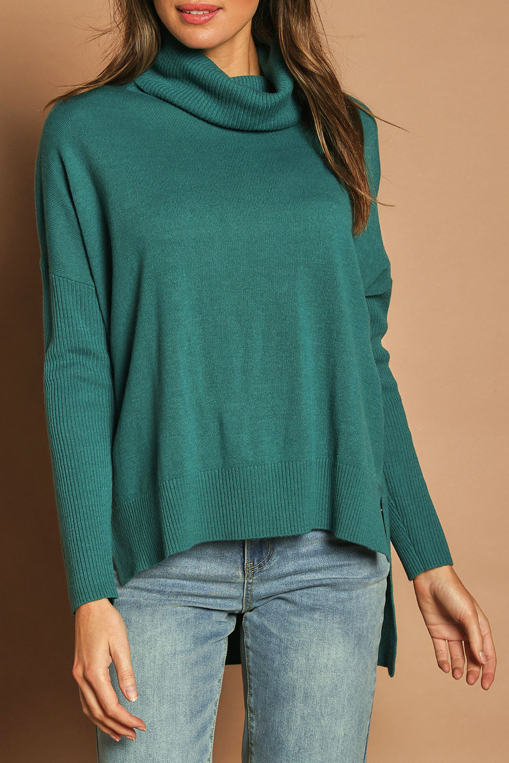 Model Madeline wearing size S of The Essential Soft High Low Jumper in colour Seagreen (Green), from the front, cropped image