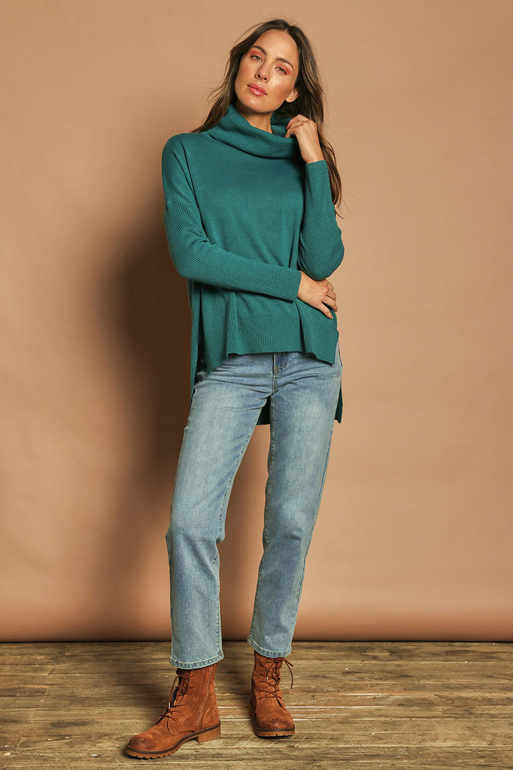 Model Madeline wearing size S of The Essential Soft High Low Jumper in colour Seagreen (Green), from the front, showing the whole outfit