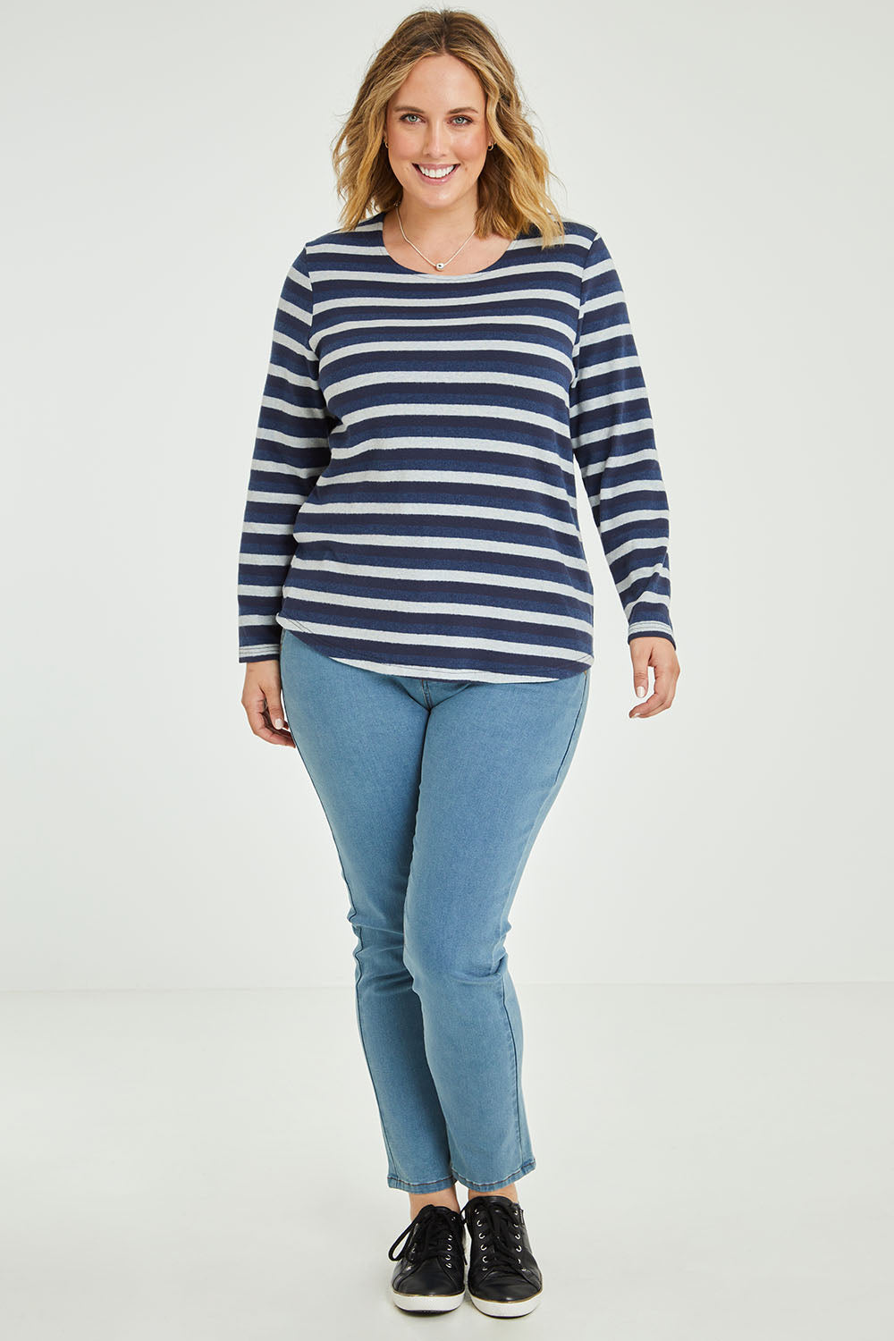 Model Jess wearing size 14 of The Multi Coloured Striped Tee in colour Denim (Blue), from the front, showing the whole outfit