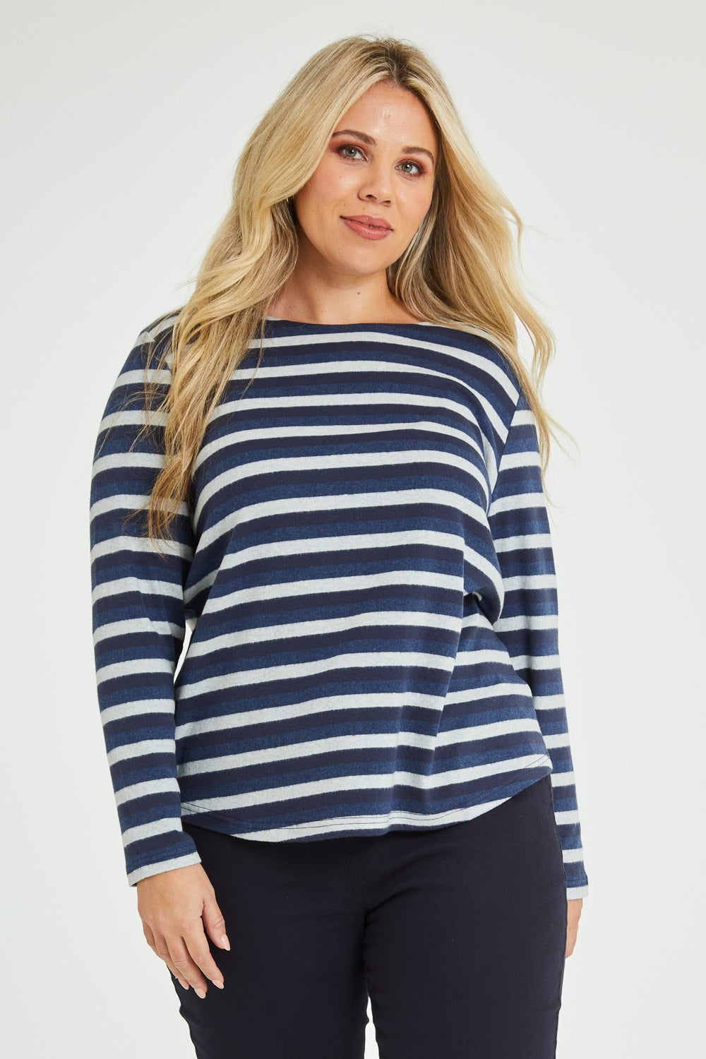 Model Katie wearing size 16 of The Multi Coloured Striped Tee in colour Denim (Blue), from the front, cropped image
