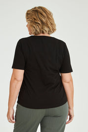 Model Fiona wearing size 16 of The Keepers Tee in colour Black (Black), from the back