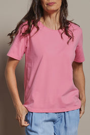 Model Amanda wearing size 10 of The Keepers Tee in colour Blush (Pink), from the front, cropped image