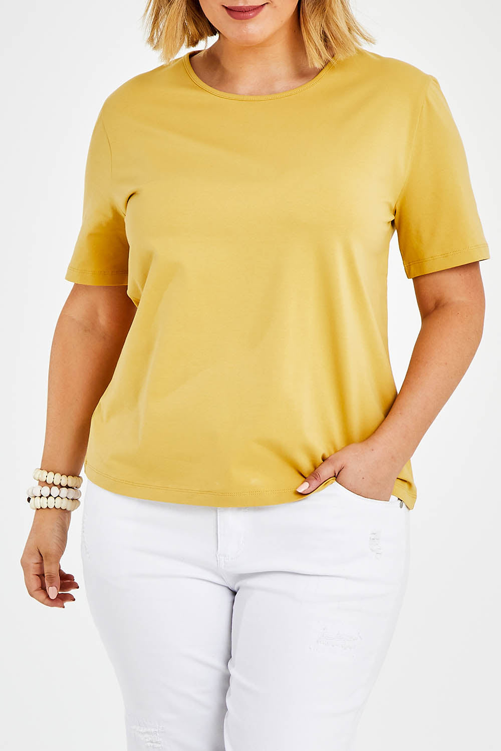 Model Jess wearing size 14 of The Keepers Tee in colour Camel, from the front, cropped image