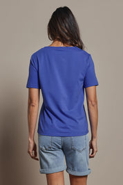 Model Amanda wearing size 10 of The Keepers Tee in colour Cobaltblue (Blue), from the back