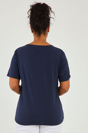 Model Noli wearing size 14 of The Keepers Tee in colour Darknavy (Blue), from the back
