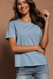 Model Madeline wearing size 10 of The Keepers Tee in colour Dustyblue (Blue), from the front, showing the whole outfit
