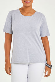 Model Noli wearing size 14 of The Keepers Tee in colour Greymarle (Grey), from the front, cropped image