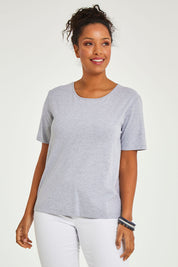 Model Noli wearing size 14 of The Keepers Tee in colour Greymarle (Grey), from the front, cropped image