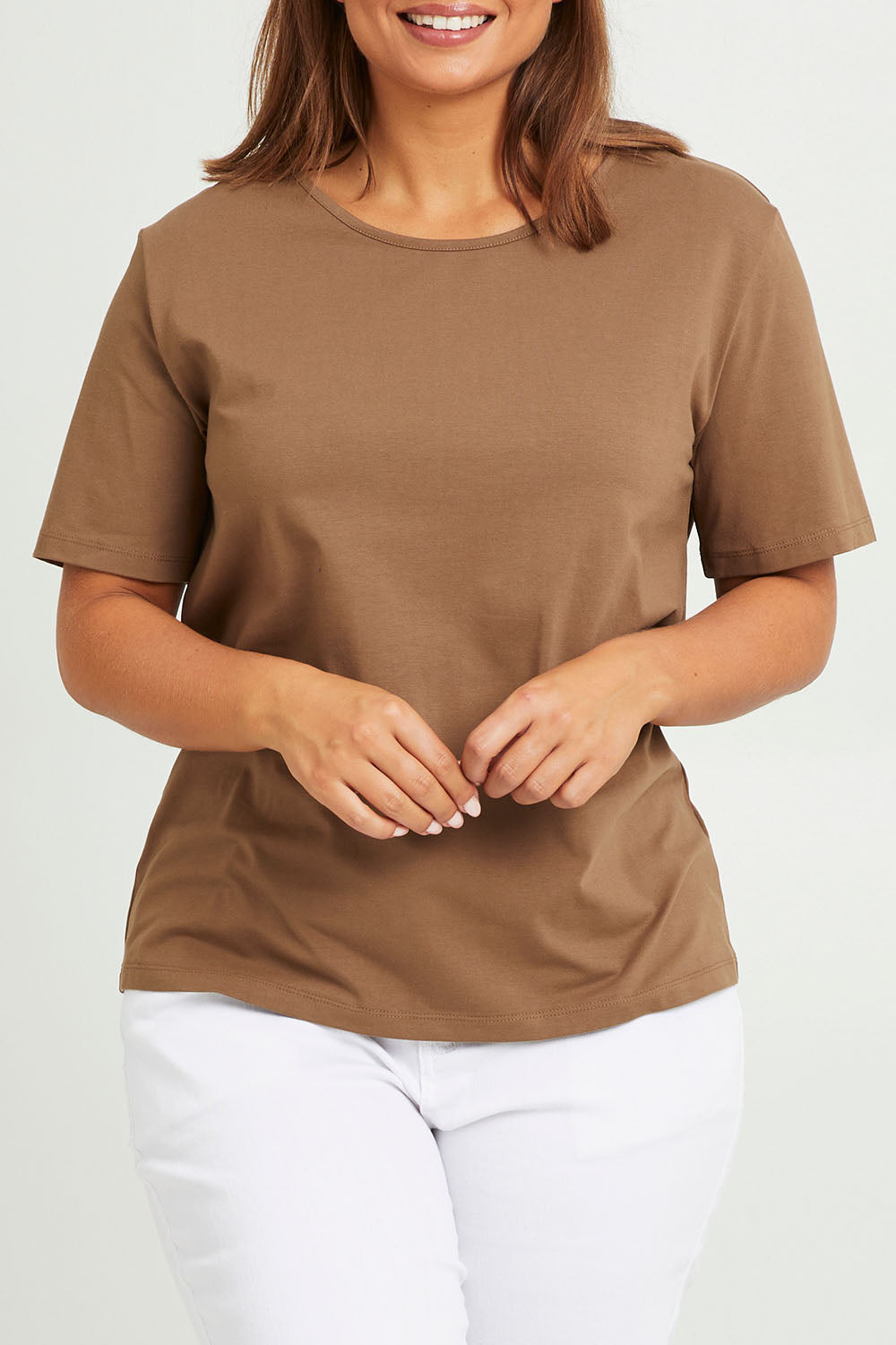 Model Monique wearing size 14 of The Keepers Tee in colour Mushroom, from the front, cropped image