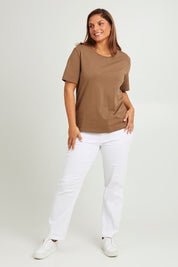 Model Monique wearing size 14 of The Keepers Tee in colour Mushroom, from the front, showing the whole outfit