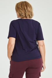 Model Fiona wearing size 16 of The Keepers Tee in colour Navy (Blue), from the back