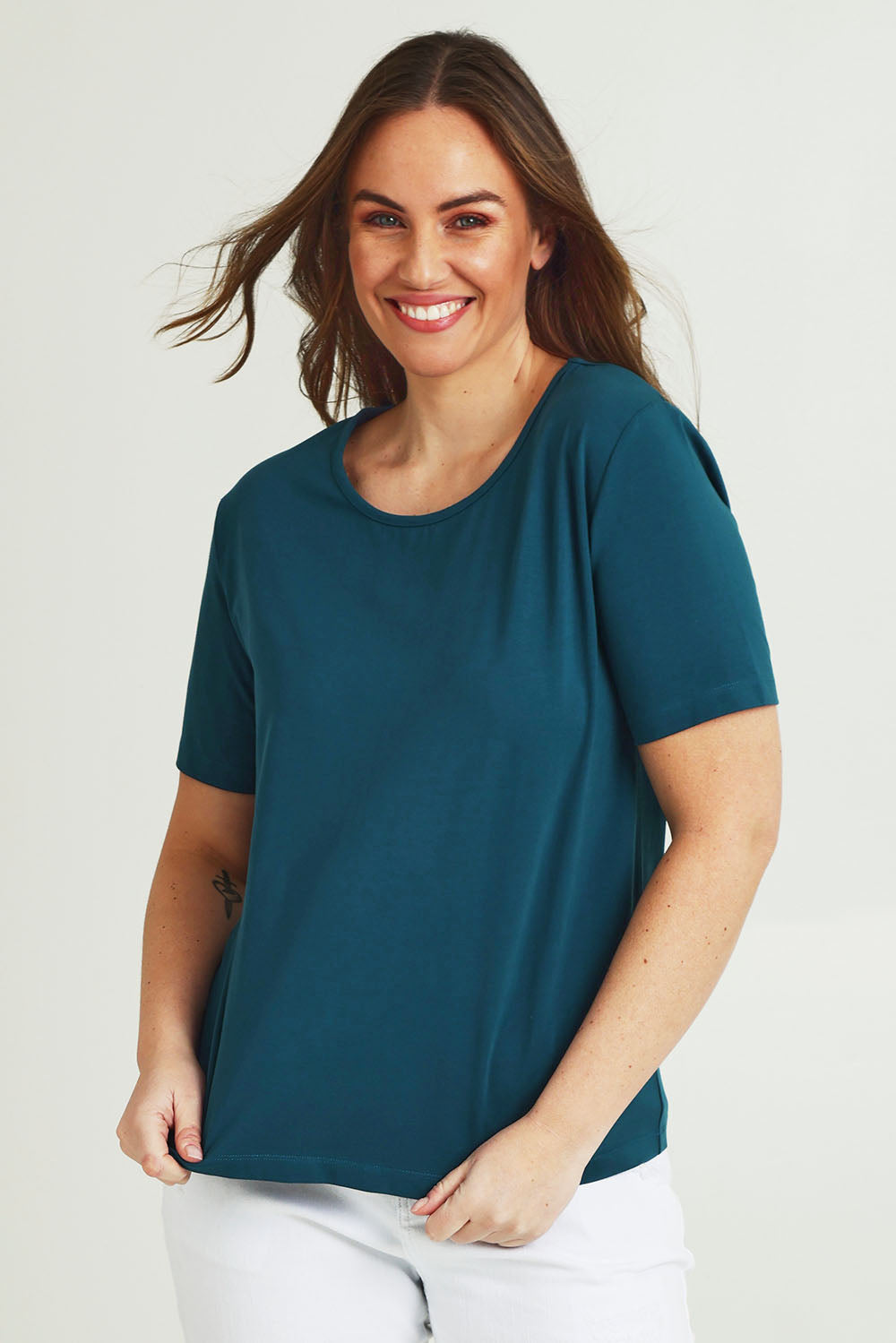 Model Janed wearing size 14 of the The Keepers Cotton Tee – Opal in colour Opal, in a cropped view