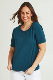 Model Janed wearing size 14 of the The Keepers Cotton Tee – Opal in colour Opal, in a cropped view